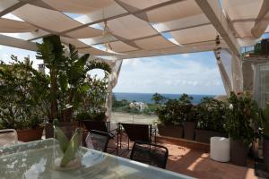 a patio with a table and chairs and the ocean at Palazzo Monterone in Forio d'Ischia