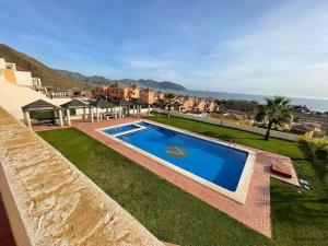 a swimming pool in the middle of a yard at Amazing Sea View! in Isla Plana