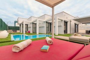 a villa with a pool and a pink blanket at Villa Tania in Can Picafort