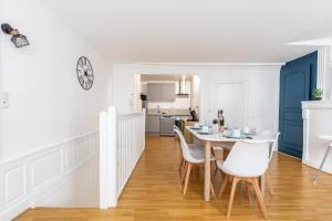 a kitchen and dining room with a table and chairs at Le Petit Pirou # Cosy # Halte Auvergne in Thiers +19 photos