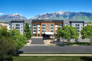 a view of a hotel with mountains in the background at Courtyard by Marriott Salt Lake City Sandy in Sandy