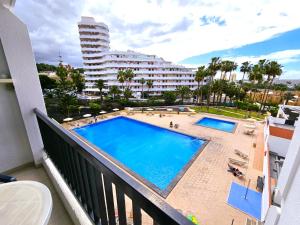 - une vue sur la piscine depuis le balcon d'un bâtiment dans l'établissement Viñas del Mar with Sea View, à Playa de las Americas