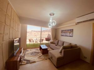 a living room with a couch and a large window at المونت جلاله - ll Monte Galala Ain Sokhna in Ain Sokhna