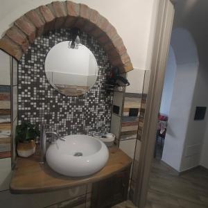 a bathroom with a sink and a mirror at Ballu e' ischina in Baunei