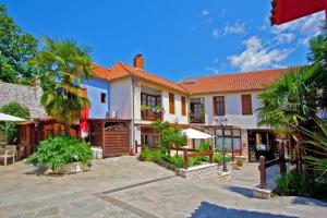a large house with a courtyard in front of it at Politia in Ioannina