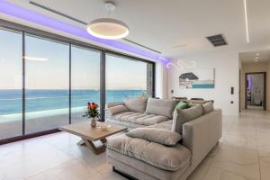 a living room with a couch and a table at Rocca al Mare Seaside Villas in Palaiokastro
