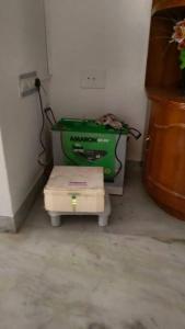 a corner of a room with a green appliance at Ohm Shanthi Homestay in Puducherry