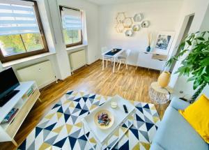 sala de estar con sofá azul y mesa en Moderne Wohnung in Vorstadtidylle zu Bayreuth, en Heinersreuth