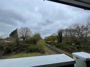 a view from a train window of a train track at Addlestone and Chertsey Stylish and Modern 4 bedroom 4 bathroom Townhouse in Addlestone