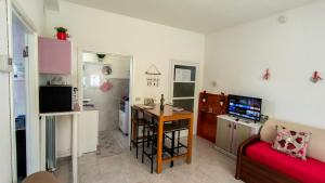 a small living room with a table and a couch at Sweetheart Apartment in Busto Arsizio