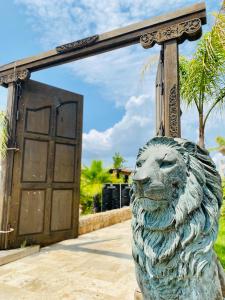 a statue of a lion in front of a door at Bella Vista Hôtel, Suites & Maisons in Porticcio