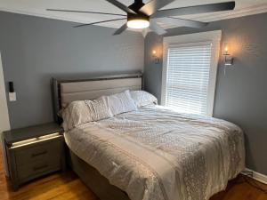 a bedroom with a bed with a ceiling fan at Spacious 5 Bed 2 Bath near Syracuse University and Downtown Syracuse With Lots of Amenities and Free Parking in Syracuse