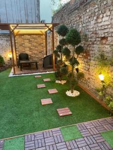 a small garden with trees and a brick wall at Ultima apartment in Istanbul