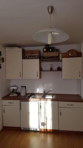 a kitchen with white cabinets and a sink at Kellergeschoss Wohnung Moto GP Wochenende in Kraubath an der Mur