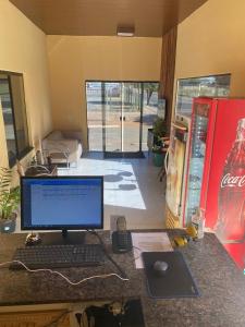a computer on a desk with a keyboard and mouse at Hotel Bee's Sorriso in Sorriso