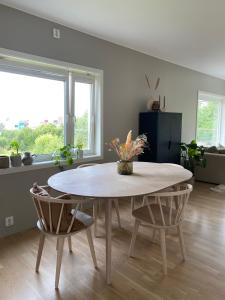 a dining room with a table and two chairs at Moderne leilighet, 3 sov, parkering. in Trondheim