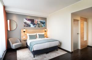 A bed or beds in a room at Leonardo Boutique Hotel Linz City Center