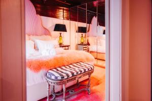 a bedroom with a large bed with a bench in it at Thomas Telford Lettings - Luxurious Interiors and Seaviews in Halistra