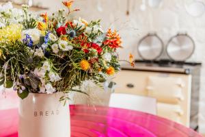 a vase filled with flowers sitting on a table at Thomas Telford Lettings - Luxurious Interiors and Seaviews in Halistra
