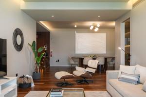 a living room with a couch and chairs and a table at Savoy Residence Casa Branca II by An Island Apart in Funchal
