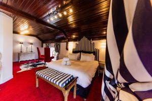 a bedroom with a large bed and a bench at Thomas Telford Lettings - Luxurious Interiors and Seaviews in Halistra