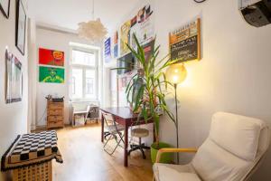 a living room with a table and a chair at FRO-MEDIA - Streetside Room 2 - Community Space in Vienna