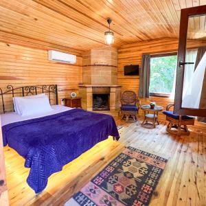 a bedroom with a bed and a fireplace at Tartaruga Boutique Hotel & Bungalows in Şile