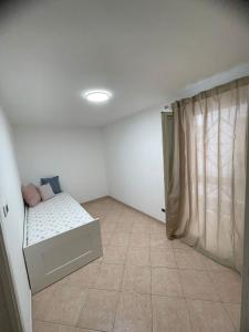 a small bedroom with a bed in a room at ARIEL HOUSE in Bari