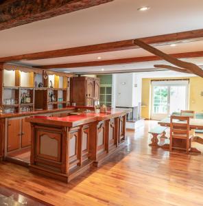 a kitchen with a large island with red counter tops at Maison Ainerak gîte à Sainte Engrace in La Pierre Saint Martin
