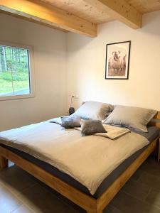 a bed with two pillows on it in a bedroom at Ferienwohnungen zum Klammlhof in Ebene Reichenau