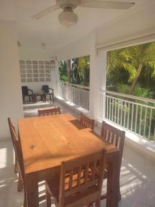 a dining room with a wooden table and chairs at Caoba in Las Terrenas