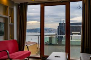 a room with a window with a view of the water at Bosphorus Menekshe Rezidances in Istanbul