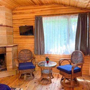 a living room with a table and chairs and a tv at Tartaruga Boutique Hotel & Bungalows in Şile