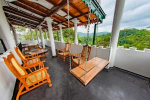 a porch with chairs and tables on a balcony at The Castle by Don Louis in Kandy