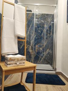 a bathroom with a shower with a glass door at La casa sui tetti in Catania +21 photos