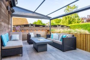 a patio with two couches and a table at Huis @ Sint Kruis in Bruges