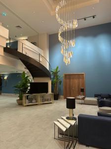 a lobby with a staircase and a chandelier at V Center Hotel in Trabzon