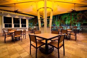 a restaurant with wooden tables and chairs at Marriott's Cypress Harbour Villas in Orlando