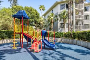 a playground with a slide in front of a building at Marriott's Cypress Harbour Villas in Orlando