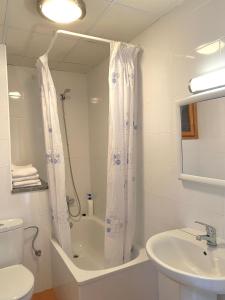 a bathroom with a sink and a toilet and a mirror at Hostal Alt Llobregat in Castellar de NʼHug