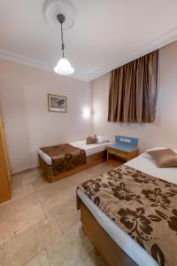 a hotel room with two beds and a window at Extrahome in Alanya