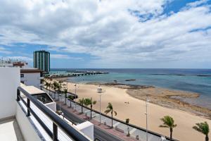 a view of the beach from a balcony at Luxury Beach Views 2BR House - Private Parking in Arrecife