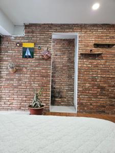 a brick wall with a window and a sign on it at Green Cocoon in Ho Chi Minh City