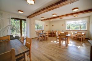 a dining room with wooden tables and chairs at Lawendowy Staw in Cisna
