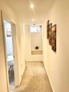 a hallway with two paintings on the wall at Lovely one bed Fitzrovia/soho in London