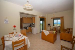 a kitchen and living room with a table and chairs at Xenios Zeus Apartments in Kissamos