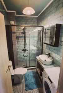 a bathroom with a shower and a toilet and a sink at Elpida Suites in Nea Irakleia