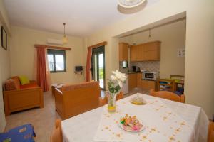 a kitchen and living room with a table and chairs at Xenios Zeus Apartments in Kissamos