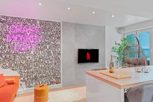 a living room with a wall mural with a tv at Das CRAZY MONKEY LOFT mit 100qm & Summerlounge in Stuttgart