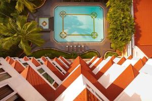 a painting of a building with a swimming pool at The Gateway Hotel Beach Road, Calicut in Kozhikode